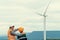 Progressive engineer with his son in the wind farm atop of the mountain.