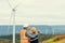 Progressive engineer with his son in the wind farm atop of the mountain.