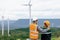 Progressive engineer with his son in the wind farm atop of the mountain.