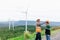 Progressive engineer with his son in the wind farm atop of the mountain.