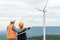 Progressive engineer with his son in the wind farm atop of the mountain.