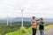 Progressive engineer with his son in the wind farm atop of the mountain.