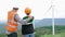 Progressive engineer with his son in the wind farm atop of the mountain.