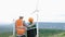 Progressive engineer with his son in the wind farm atop of the mountain.