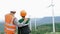 Progressive engineer with his son in the wind farm atop of the mountain.