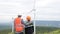 Progressive engineer with his son in the wind farm atop of the mountain.