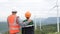 Progressive engineer with his son in the wind farm atop of the mountain.