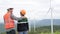 Progressive engineer with his son in the wind farm atop of the mountain.