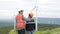 Progressive engineer with his son in the wind farm atop of the mountain.