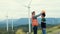 Progressive engineer with his son in the wind farm atop of the mountain.