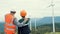 Progressive engineer with his son in the wind farm atop of the mountain.