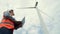 Progressive engineer working with the wind turbine, with the sky as background.