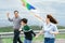 Progressive happy carefree family vacation concept flying kite with wind turbine