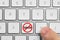 Prohibition sign with word Spam on button, top view. Man using computer keyboard, closeup