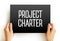 Project Charter - statement of the scope, objectives, and participants in a project, text concept on card