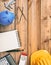 Project construction cost budget. Top view of piggy bank, calculator and engineering equipment on a wooden desk, copy space