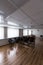 Projector hang on ceiling of empty sunlit meeting room