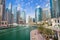 Promenade and canal in Dubai Marina with luxury skyscrapers around,United Arab Emirates