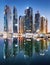 Promenade and canal in Dubai Marina at night with luxury skyscrapers around,United Arab Emirates