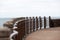 Promenade with metallic handrail and sea