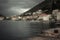 Promenade in old medieval port town Lapetane in rainy overcast day in Montenegro