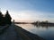 Promenade by the river Drava and pedestrian bridge during a sunny evening