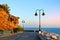 Promenade of Torremolinos, a road, rocks, blooming bushes and Mediterranean sea