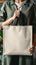 Promoting eco friendly living Woman holds blank canvas shopping bag