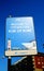 Promotional sign of the commercial port of Civitavecchia on a pole with blue sky. Copy space