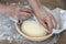 Proofing bread dough in basket, hands, towel