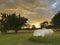 Propane tank in the summer countryside with storm clouds