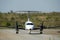 Propeller plane leaving the runway, heading down the taxiways to the airport gates