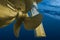 Propeller and rudder of big ship underway view from underwater. Close up image detail of ship