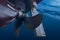 Propeller and rudder of big ship underway view from underwater. Close up image detail of ship