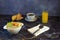 Proper and healthy breakfast, a cup of oatmeal with fruit, a glass of orange juice, two fresh croissants and a cup of black coffee