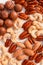 Proper nutrition composition of assorted nuts pattern vertical photo for banner, article or packaging. Pecans, brazil