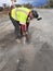 Proper personal protection equipment being worn by construction worker while cutting asphalt on road project