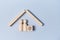 Property investment mockup. Buying and selling real estate. Mortgage. Wooden house, person figures, cube with coin sign