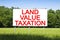 Property Land Tax on vacant plot - real estate concept with a vacant land on a green field available for building construction and