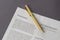 Property release letterhead and gold-colored pen on gray table