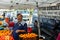 A proprietor of a produce booth smiles and laughs with a customer at the Canoga Park Farmer`s Market on Owensmouth Ave.