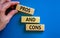 Pros and cons symbol. Wooden blocks with words `Pros and cons`. Beautiful blue background, businessman hand. Business, pros and