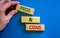 Pros and cons symbol. Wooden blocks with words `Pros and cons`. Beautiful blue background, businessman hand. Business, pros and