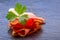 Prosciutto. Curled Slices of Delicious Prosciutto with parsley leaves on granite board. Prosciuto with spice cherry tomatoes