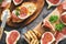 Prosciutto with figs . Fresh figs with ham and cheese on a grilled toast, rustic background. Appetizing snack. Top view,toned