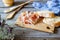 Prosciutto ham and bread on a wooden background. Italian cuisine. Rustic style