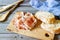 Prosciutto ham and bread on a wooden background. Italian cuisine. Rustic style