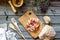 Prosciutto ham and bread on a wooden background. Italian cuisine. Rustic style