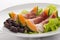 Prosciutto, melon, salad leaf and olives