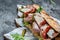 Prosciutto sandwich, Ciabatta with prosciutto, sun-dried tomatoes, gherkins, parmesan and arugula, banner, menu, recipe place for